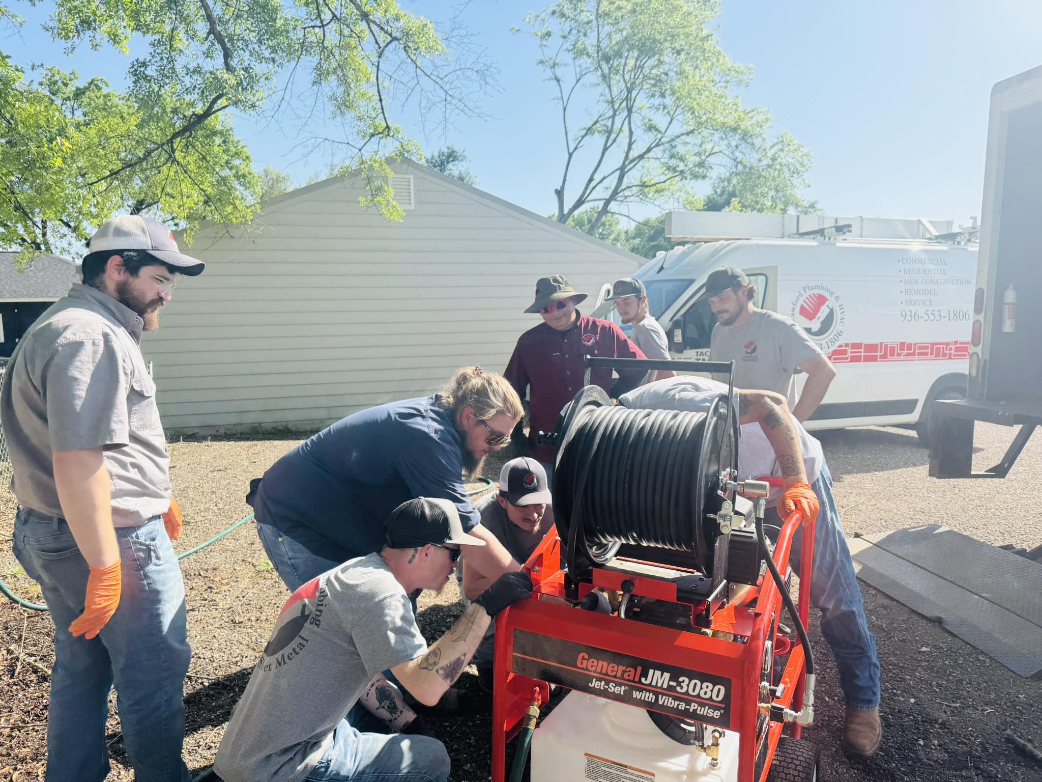 Crew members of Crawford Plumbing, HVAC & Sheet Metal receive training on hydrojetting equipment.