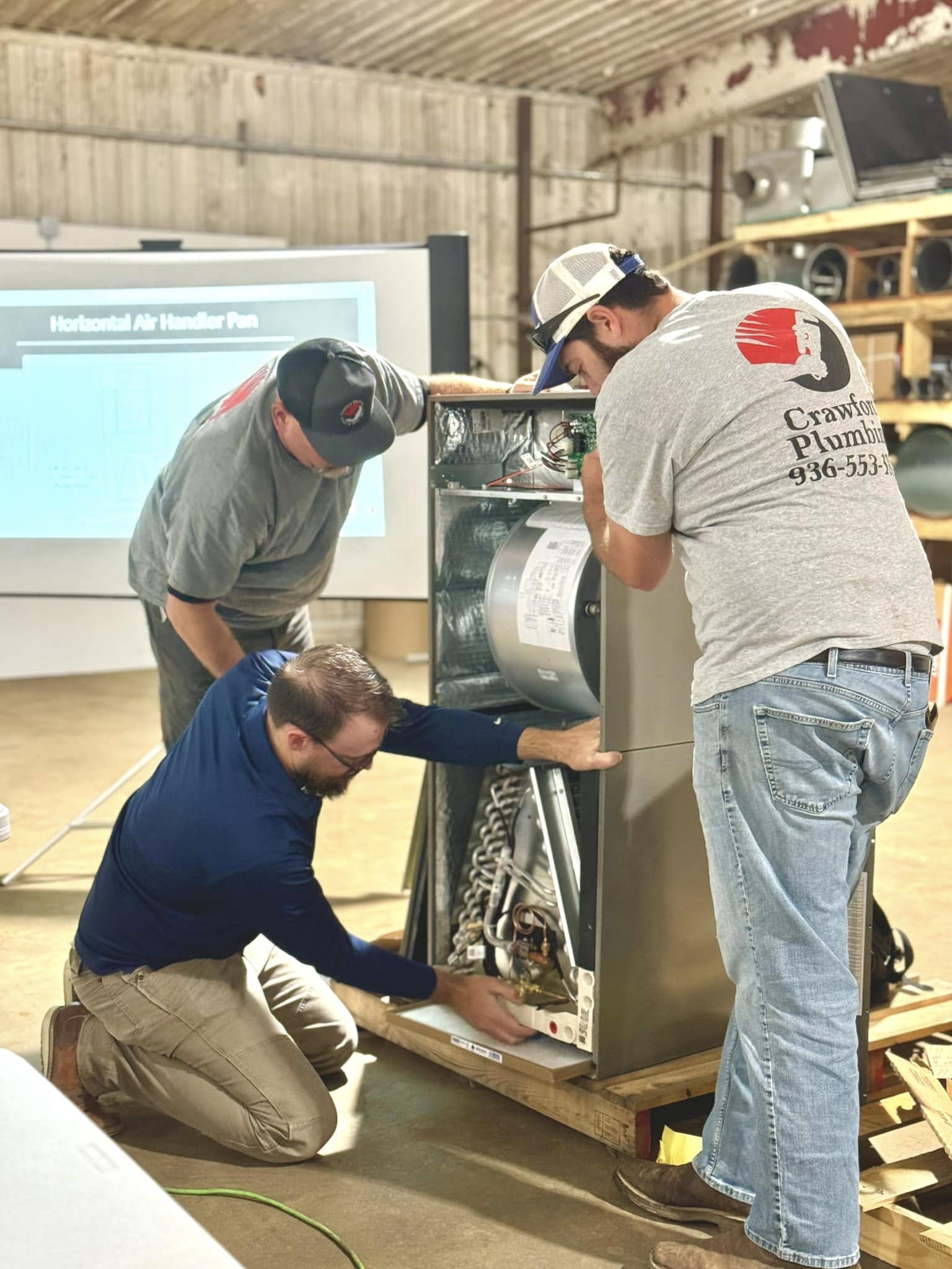 Crawford Plumbing, HVAC & Sheet Metal crew members receive training on HVAC maintenance.